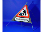 Men at work, road sweeping roll up road sign