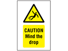 Caution, Mind the drop symbol and text safety sign.