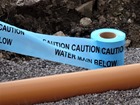 Caution water main below tape.