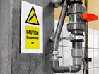 Caution Compressed air symbol and text safety sign.