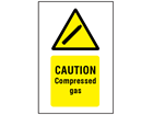 Caution compressed gas symbol and text safety sign.