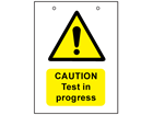 Caution, test in progress safety sign.