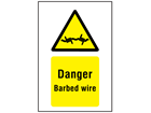 Danger barbed wire symbol and text sign.