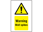 Warning wall spikes symbol and text sign.