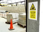 Caution Fork lift trucks in operation symbol and text safety sign.