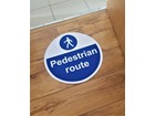 Pedestrian route symbol and text floor graphic marker.