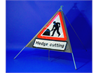 Men at work, hedge cutting roll up road sign