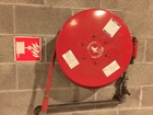 Fire hose reel symbol safety sign.