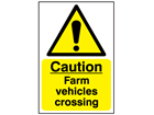 Caution, farm vehicles crossing safety sign.