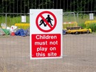 Children must not play on this site symbol and text safety sign.
