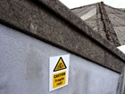 Caution Fragile roof symbol and text safety sign.
