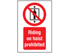 Riding on hoist prohibited symbol and text safety sign.