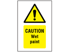 Caution Wet paint symbol and text safety sign.