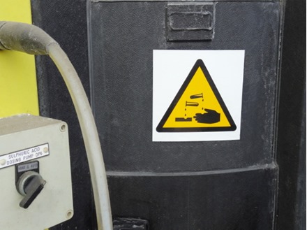 Caution corrosive symbol safety sign.