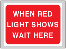 When red light shows wait here roll up road sign