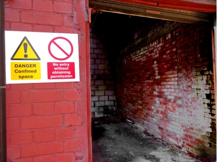Danger confined space, no entry without obtaining permission safety sign.