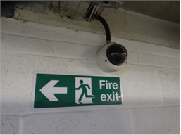 Fire exit arrow left symbol and text safety sign.
