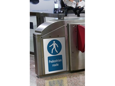 Pedestrian route symbol and text safety sign.