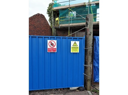 Danger Demolition in progress symbol and text safety sign.