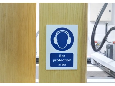 Ear protection area symbol and text safety sign.