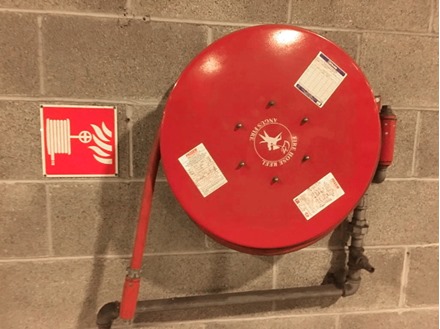 Fire hose reel symbol safety sign.