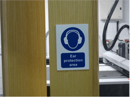 Ear protection area symbol and text safety sign.