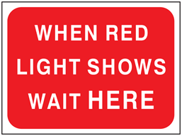 When red light shows wait here temporary road sign.
